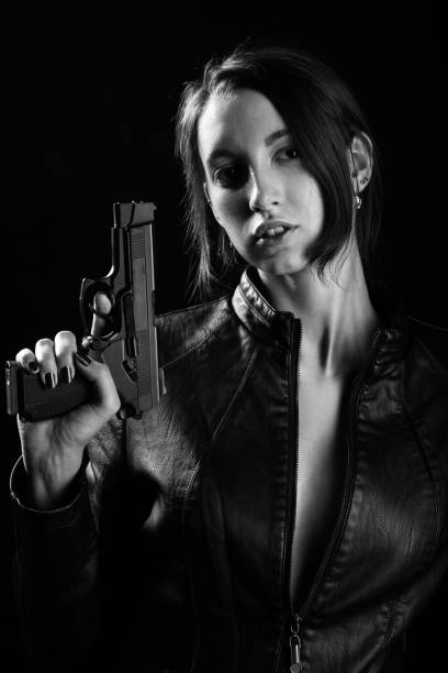istock girl with gun 1164923688