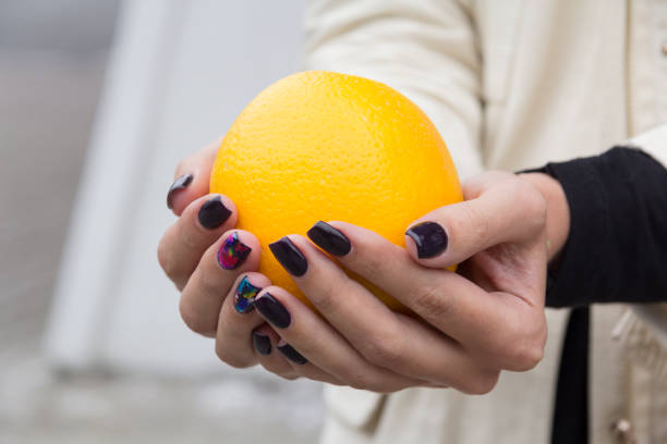 istock Girls hold hands orange 1164923705