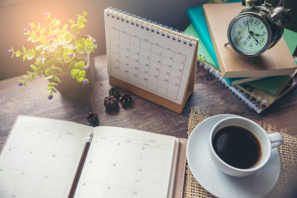 istock Diary,Calendar and agenda for Planner to make timetable,appointment,organization,management on table.Desktop Calender 2019 and cup of coffee place on wooden office desk.Calendar Background Concept. 1164925525