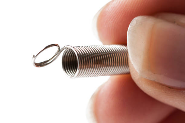 Metal spring in hand isolated on white background