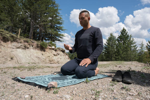 istock Man praying outdoors in nature 1164927587