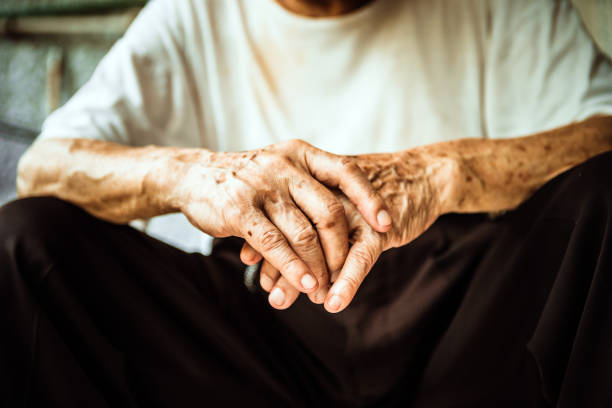 istock Senior man sitting on chair and cross hands 1164929286