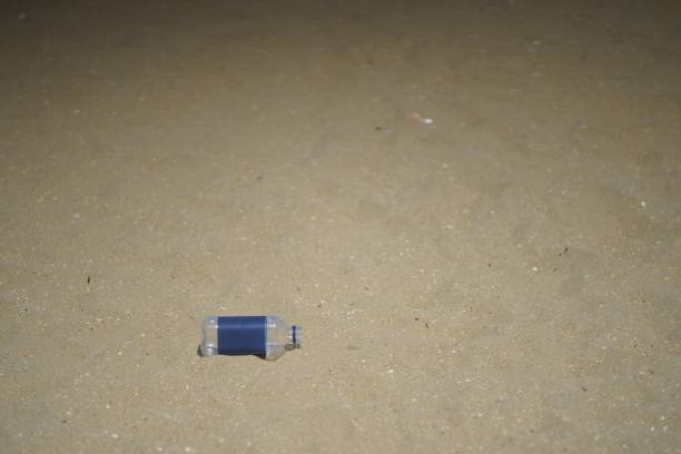 istock plastic bottle on sand pollute the beach background copy space 1164933502
