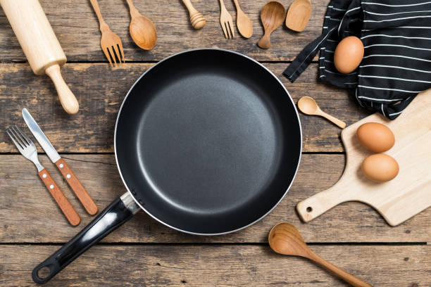 istock Cooking background,Top View of a Pan and different kitchenware On Old Wood Background 1164933748