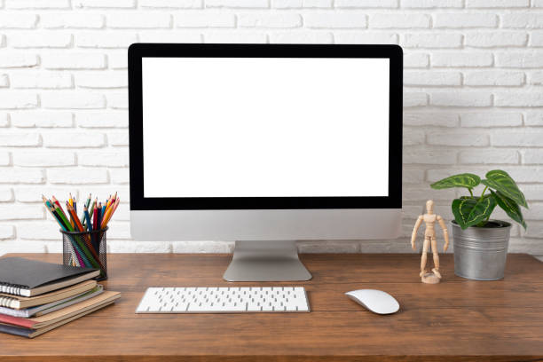 istock workspace with computer with blank white screen, and office supplies on a wooden desk 1164933769