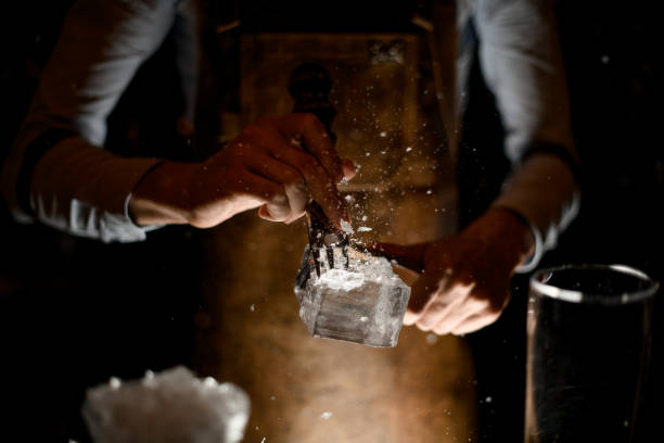 istock Bartender crushing piece of ice with picker 1164935146