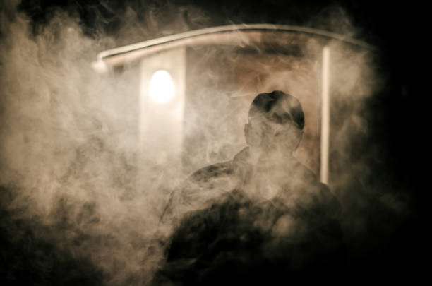 istock smoking man in fume haze 1164935949