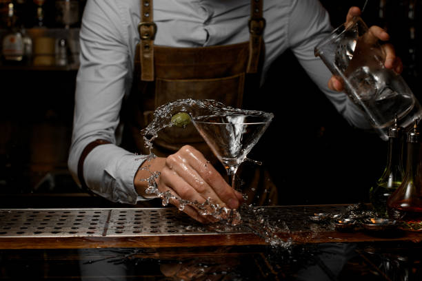 istock Bartender pours a martini cocktail from the jar 1164936316