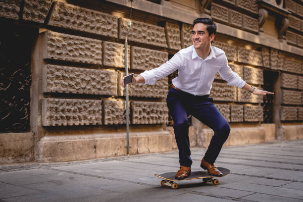 istock young businessman on skateboard 1164936488
