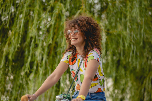 istock a young woman on a bicycle 1164937223