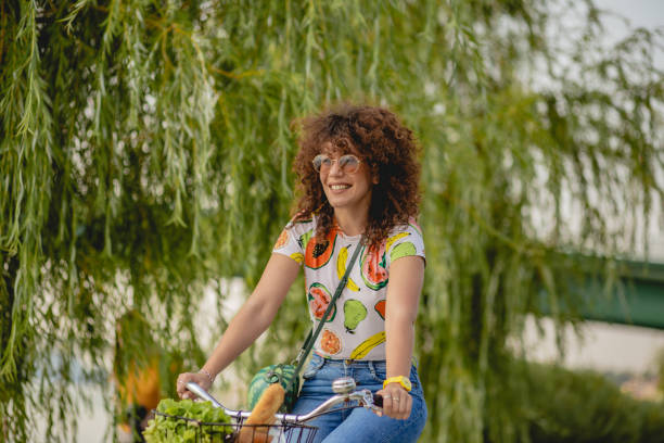 istock a young woman on a bicycle 1164937247