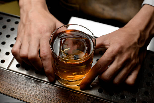 istock Close shot of a whiskey with ice inside 1164937433