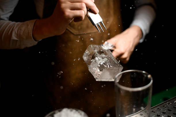 istock Close shot of bartender crushing the ice cube 1164937445