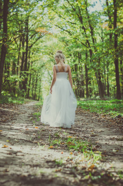 istock adorable child in long white wedding dress 1164937598
