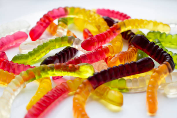 istock Coloured jelly worms funny background 1164938096
