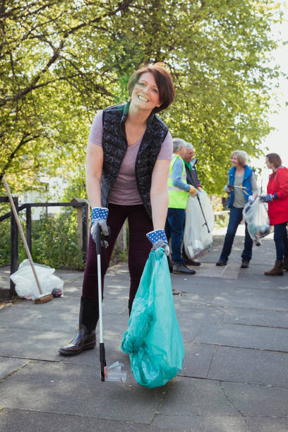 istock Woman Collecting Litter 1164938622