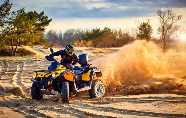 istock Racing powerful quad bike on the difficult sand in the summer. 1164938862