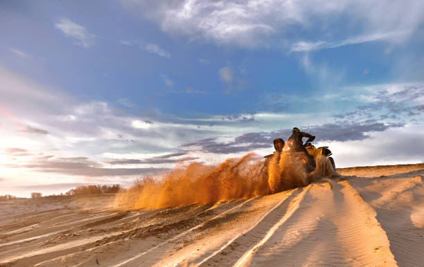 istock Racing powerful quad bike on the difficult sand in the summer. 1164939105