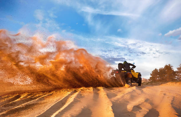 istock Racing powerful quad bike on the difficult sand in the summer. 1164939110