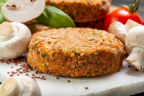 Tasty vegetarian and vegan burgers made from healthy quinoa, basil, tomatoes and champignon mushrooms Tasty vegetarian burgers made from healthy quinoa, basil, tomatoes and champignon mushrooms close up veggie burger stock pictures, royalty-free photos & images