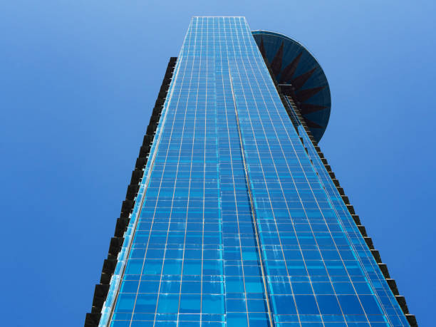 istock Modern skyscraper with glass facade on blue sky background 1164939463