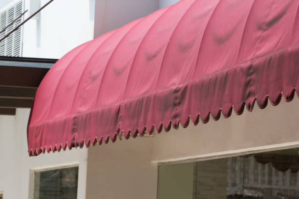 istock old red awning over glass door. 1164939509