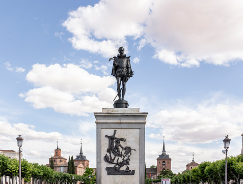 Alcala de Henares, Spain; June, 05, 2019: Statue in memory of the popular Spanish writings Miguel de Cervantes created in 1879 in bronze by the sculptor Carlo Nicoli, weighing 750 kilograms and a height of 2.09 meters