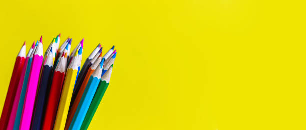 istock Color pencils on a bright yellow background. Back to school concept. Copy space for text. 1164940858