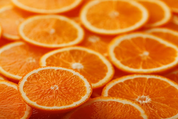 istock Slices of ripe orange backlit as a textural background. Full screen, close-up, macro 1164942745