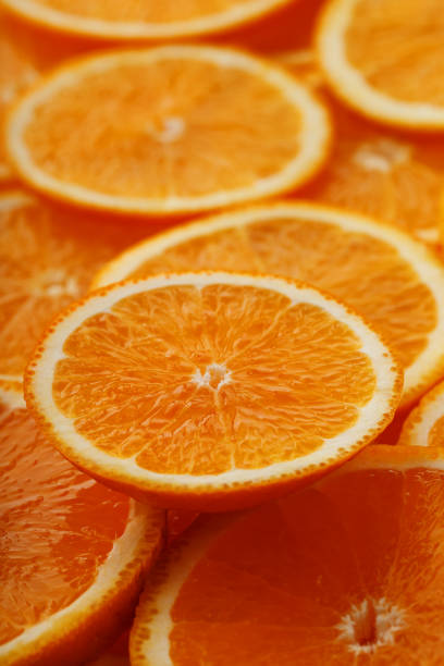 istock Slices of ripe orange backlit as a textural background. Full screen, close-up, macro 1164942826