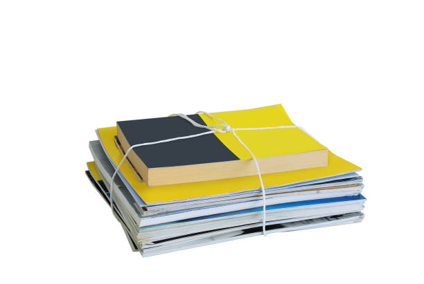 istock Garbage collection. A bundle of magazines tied with a rope. White isolate 1164944829
