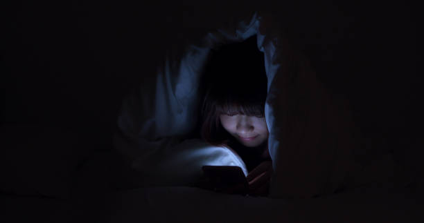 istock Woman Using Cellphone In Bed At Night 1164946834