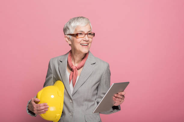 donna in possesso di casco e tablet digitale - independence business women manual worker foto e immagini stock