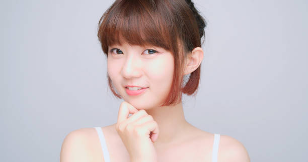 istock Asian Woman Looking At The Camera Standing On White Background 1164946889