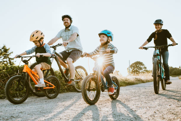 Family Mountain Bike Riding Together on Sunny Day stock photo