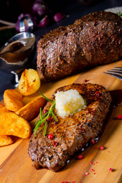 istock Butter Beef Steak with herbs and potato wedges 1164948460