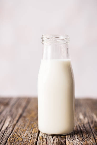 istock Bottle of milk on rustic wooden table 1164950205