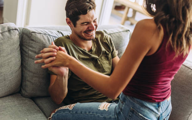 istock Playful couple having a fun at home 1164950855