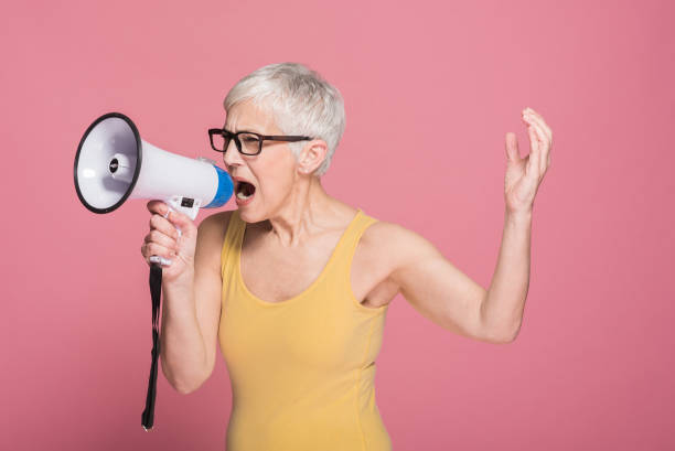 istock Woman shouting in megaphone 1164952779