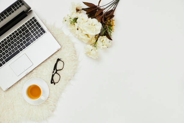 istock Workplace with laptop and flowers 1164953160