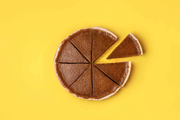 istock Pumpkin pie cut in slices and one separated 1164953291