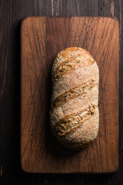 Aerial shot of a loaf of bread on cutting board