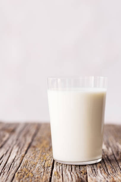 istock Glass of milk on rustic wooden table 1164958044