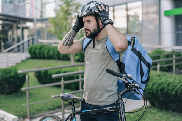 istock Courier on a cargo bike delivering packages 1164958079