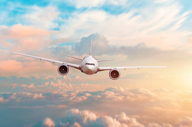 istock Airplane flying above evening light above the clouds at sunset. 1164958174