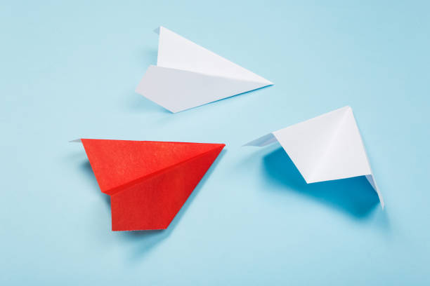 istock Red paper plane are different from others on blue background. Think different. Business for innovative, solution concepts 1164958342