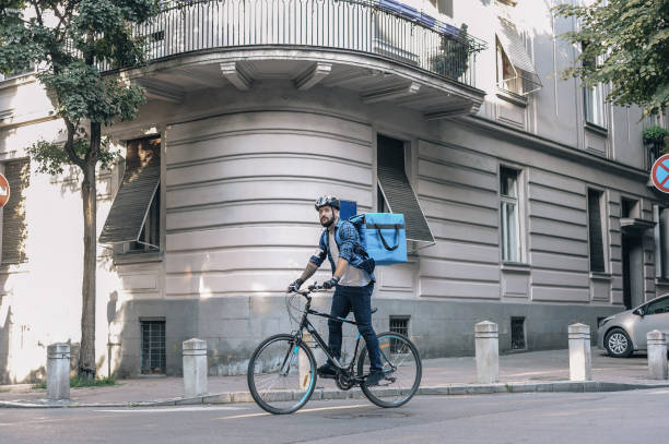 Courier delivering packages Courier delivering packages on a cargo bike cargo bike photos stock pictures, royalty-free photos & images