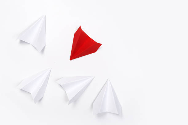 istock Red paper plane are different from others on white background. Think different. Business for innovative, solution concepts 1164958439