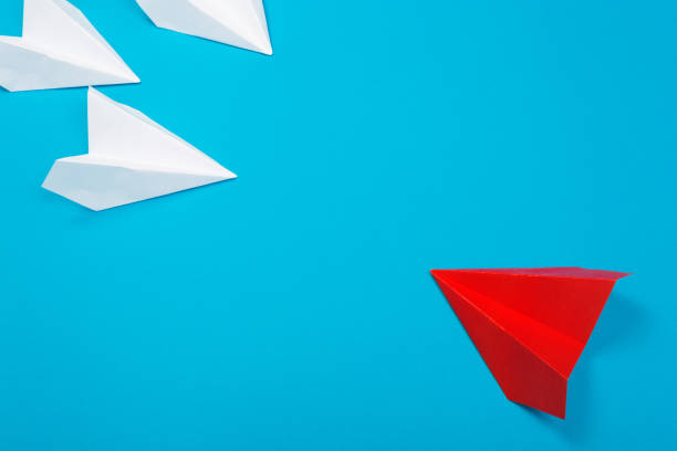 istock Red paper plane are different from others on blue background. Think different. Business for innovative, solution concepts 1164958524
