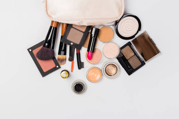 istock Makeup products with cosmetic bag and macaroons on light background 1164958589